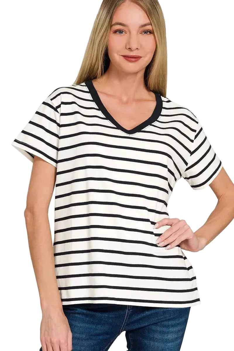 Woman wearing a black and white striped t-shirt with a plain background