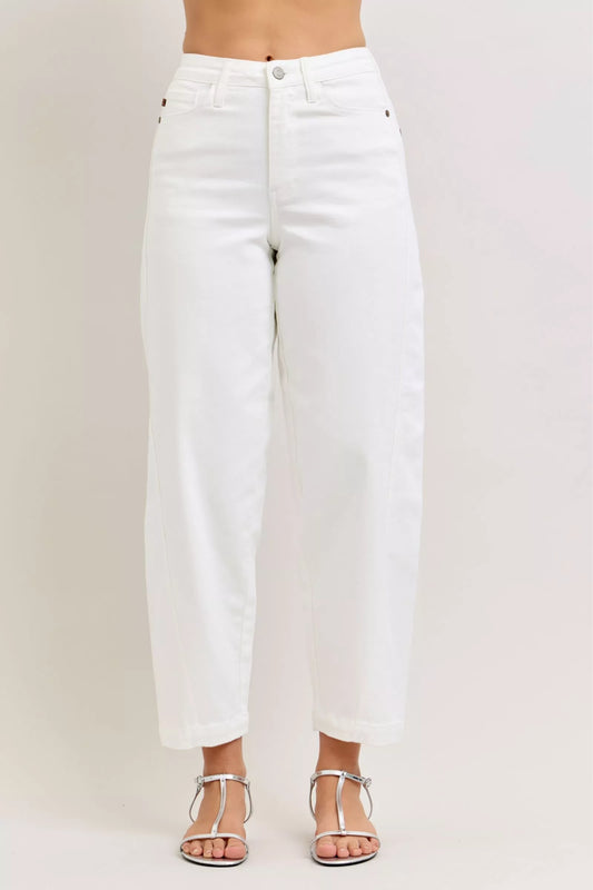 White jeans worn by a person on a plain background