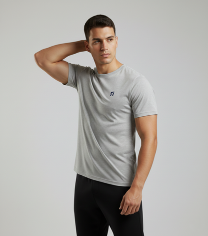 Man wearing a gray t-shirt with a logo on a plain background