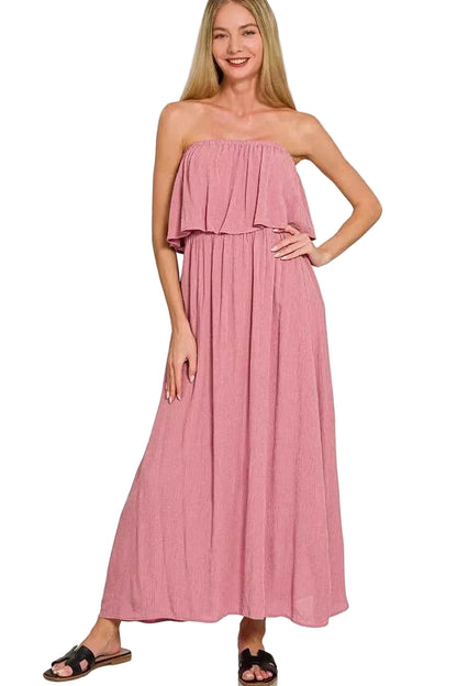 Woman wearing a pink strapless dress on a white background